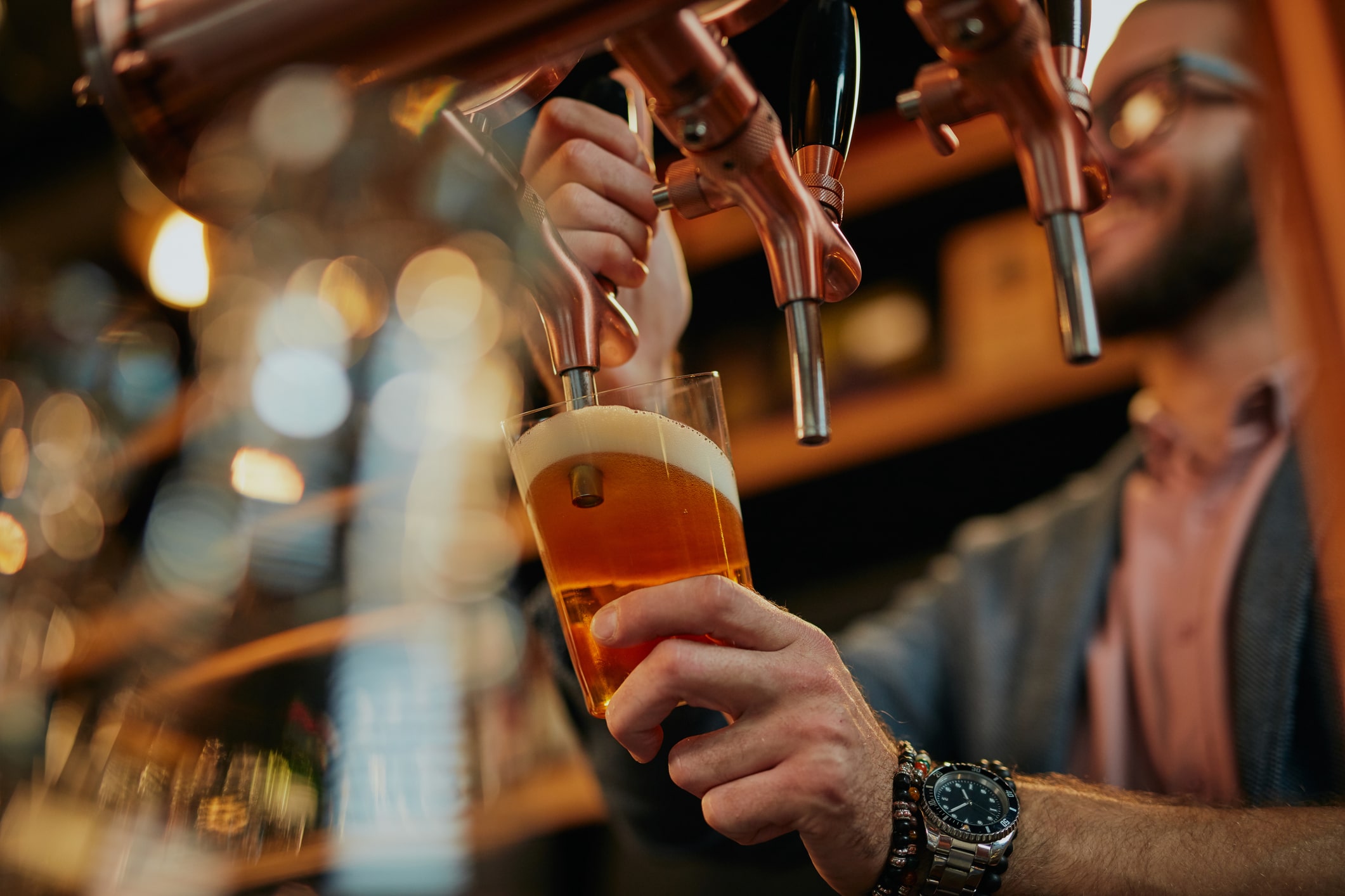 craft brewer pouring beer